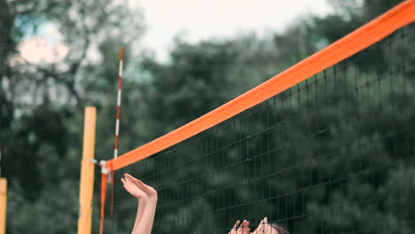 Women-Competing-in-a-Professional-Beach-Volleyball-Tournament.-A-defender-attempts-to-stop-a-shot-during-the-2-women-international-professional-beach-volleyball.